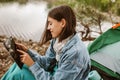Woman sitting in front of the tent using digital tablet Royalty Free Stock Photo