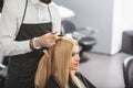 Young woman is sitting at hairdressers