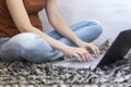 Young woman sitting on handmade carpet and working with her laptop Royalty Free Stock Photo