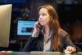 Young woman sitting at her desk working and answering a phone call. Royalty Free Stock Photo