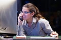 Young woman sitting at her desk working and answering a phone call. Royalty Free Stock Photo