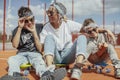 Young mum sitting with her sons at playground. Happy family concept. Royalty Free Stock Photo