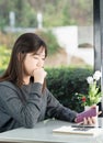 Young woman sitting holding passport and credit card Royalty Free Stock Photo