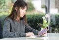 Young woman sitting holding passport and credit card Royalty Free Stock Photo