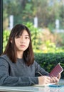 Young woman sitting holding passport and credit card Royalty Free Stock Photo