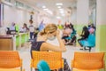 Young woman sitting in hospital waiting for a doctor`s appointment. Patients In Doctors Waiting Room