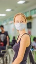 Young woman sitting in hospital waiting for a doctor`s appointment. Patients In Doctors Waiting Room VERTICAL FORMAT for Royalty Free Stock Photo