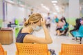 Young woman sitting in hospital waiting for a doctor`s appointment. Patients In Doctors Waiting Room Royalty Free Stock Photo
