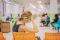 Young woman sitting in hospital waiting for a doctor`s appointment. Patients In Doctors Waiting Room Royalty Free Stock Photo