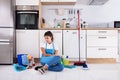 Young Woman Sitting On Kitchen Floor Royalty Free Stock Photo