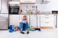 Young Woman Sitting On Kitchen Floor Royalty Free Stock Photo