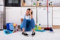 Young Woman Sitting On Kitchen Floor Royalty Free Stock Photo