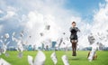 Young woman sitting on light bulb on green meadow Royalty Free Stock Photo