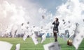 Young woman sitting on light bulb on green meadow Royalty Free Stock Photo