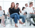 Young woman sitting among the listeners of the business seminar Royalty Free Stock Photo