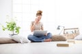 Young woman sitting in living room talking mobile phone at the computer, stay at home concept Royalty Free Stock Photo
