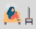 Woman sitting and looks sad. Depressed girl hugging her knees and watching tv. Mental health concept