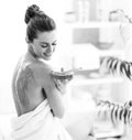 Young woman sitting on massage table with honey plate Royalty Free Stock Photo