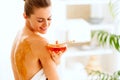 Young woman sitting on massage table with honey plate Royalty Free Stock Photo