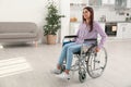 Young woman sitting in modern wheelchair