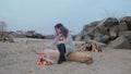 Young woman sitting near the fire in the evening. fire.