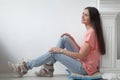 Young woman sitting near the fireplace in a modern living room Royalty Free Stock Photo