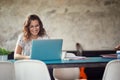 A young woman is sitting in the office and working on laptop Royalty Free Stock Photo