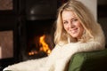 Young woman sitting by open fire