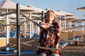 Young Woman sitting on a pier in sunrise, enjoying the view Royalty Free Stock Photo