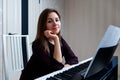 Young woman sitting and playing on the electronic piano Royalty Free Stock Photo