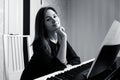 Young woman sitting and playing on the electronic piano Royalty Free Stock Photo