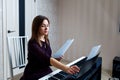 Young woman sitting and playing on the electronic piano Royalty Free Stock Photo