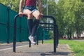 Young woman sitting on a rail in park Royalty Free Stock Photo