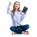 Young woman sitting reading book headphones smartphone Royalty Free Stock Photo