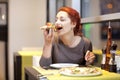 A young woman sitting in a restaurant, smilin