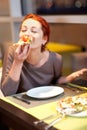 A young woman sitting in a restaurant, smilin