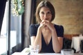 Young woman sitting at a restaurant table Royalty Free Stock Photo