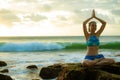 Young woman meditating, practicing yoga and pranayama with namaste mudra at the beach, Bali. Copy space Royalty Free Stock Photo