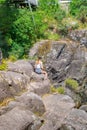 Young woman sitting on rocks