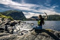 Young woman sitting on the rocks, Norway