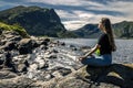 Young woman sitting on the rocks, Norway