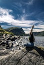 Young woman sitting on the rocks, Norway