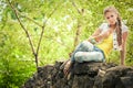 Woman sitting on rocky stones in the park