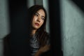 Young woman sitting sad with shadow foreground, depression emotion, looking space in dark room, Portrait of young beautiful woman Royalty Free Stock Photo