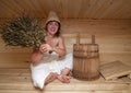 Young woman is sitting at sauna bath Royalty Free Stock Photo