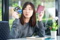 Young woman sitting showing passport and credit card Royalty Free Stock Photo