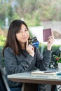 Young woman sitting showing passport and credit card Royalty Free Stock Photo