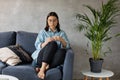 A young Woman is Sitting on the Sofa Looking at the Camera. The Girl Is Worried, Sad. Depression. Royalty Free Stock Photo