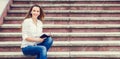 Young woman on stairs and making notes in notebook Royalty Free Stock Photo