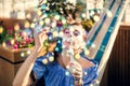 A young woman is sitting in a summer outdoor cafe in hammock and blowing soap bubbles Royalty Free Stock Photo